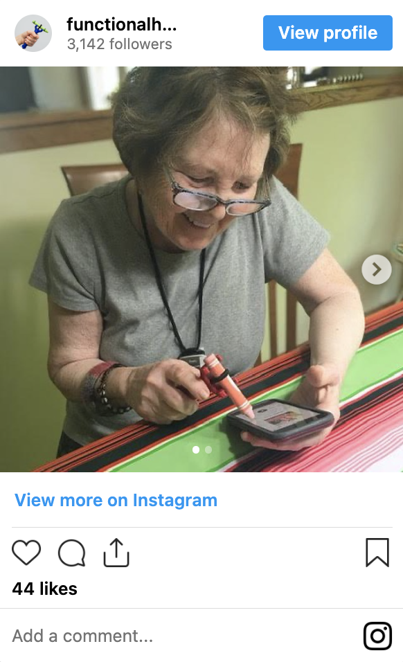 Woman with Parkinson's Disease using the functionalhand@ to use her mobile phone