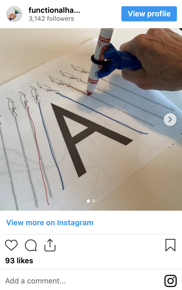 Person using the functionalhand® to trace the letter A while practicing their handwriting.