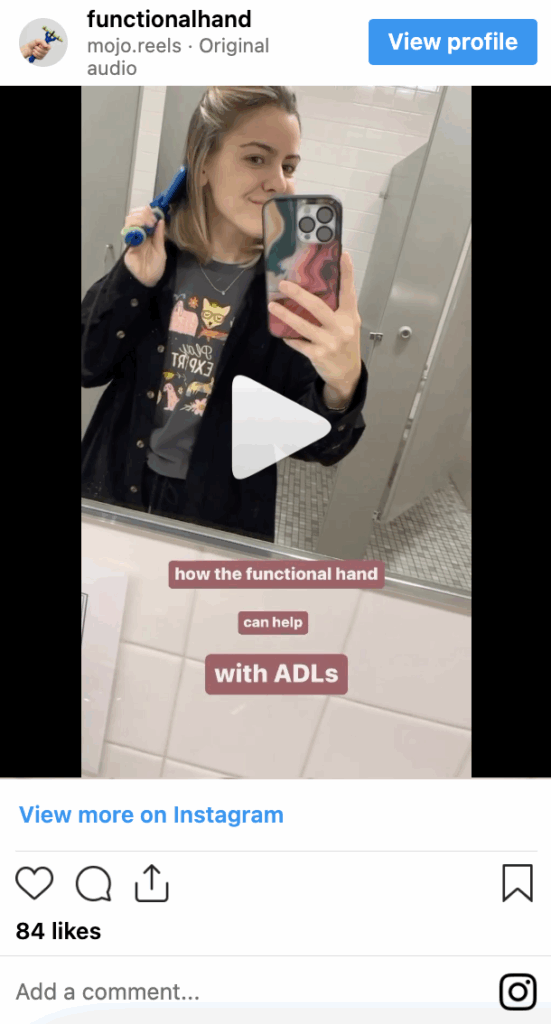 Person using the functionalhand® to brush her hair.