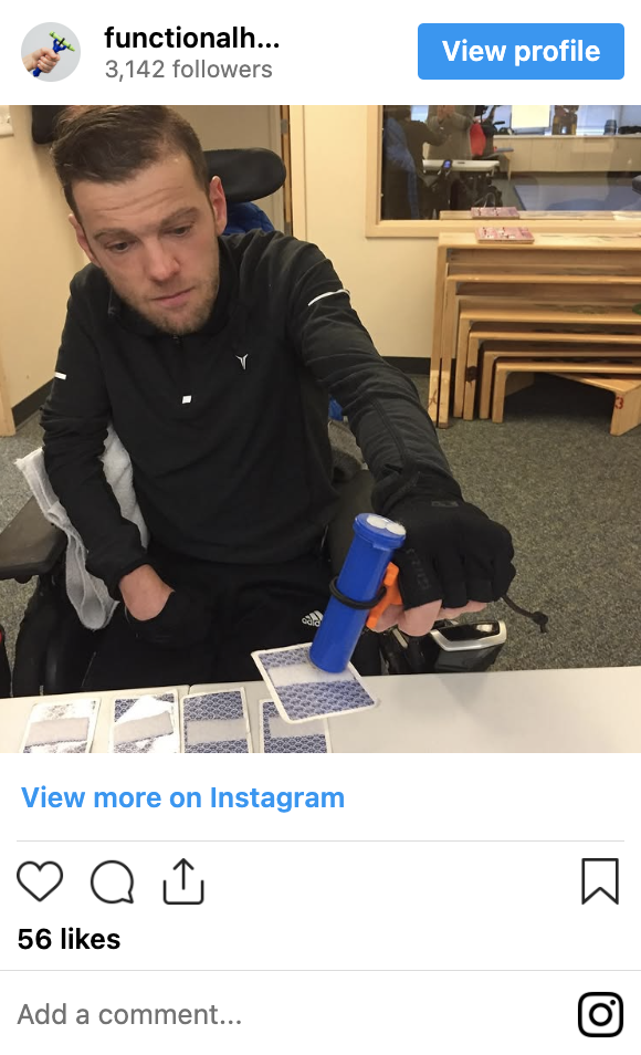 Person using the functionalhand® to play cards