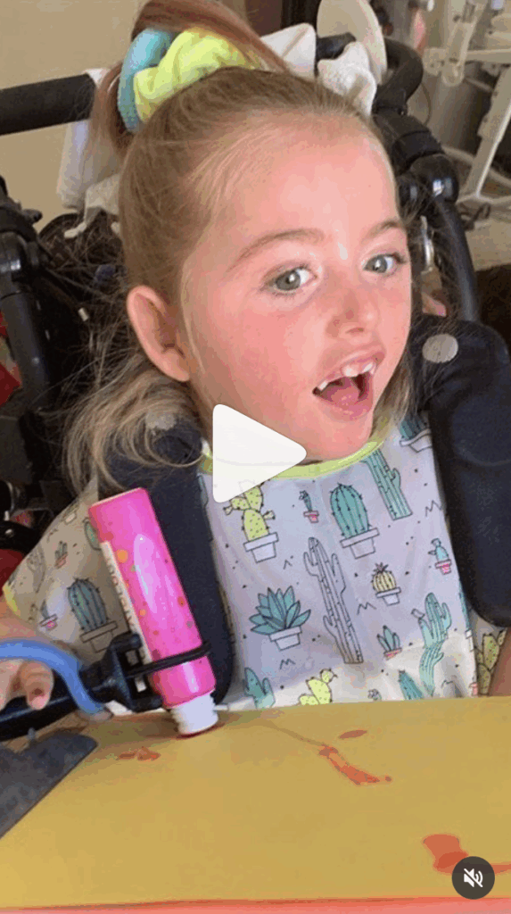 Child using the functionalhand® adaptive equipment for students to complete homework.
