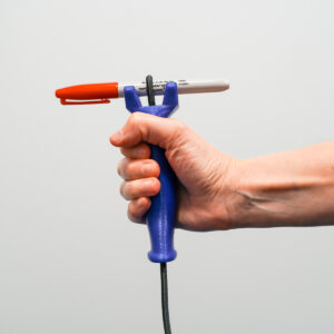 hand grasping a functionalhand adaptive aid that is holding a marker