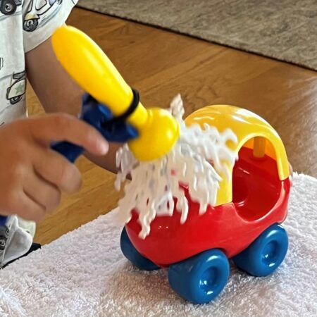 Universal cuff for children being used by a toddler playing with a toy