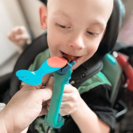 CP kid eating with spoon