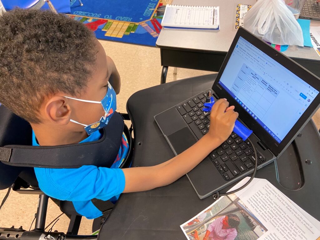 student using occupational tool and laptop