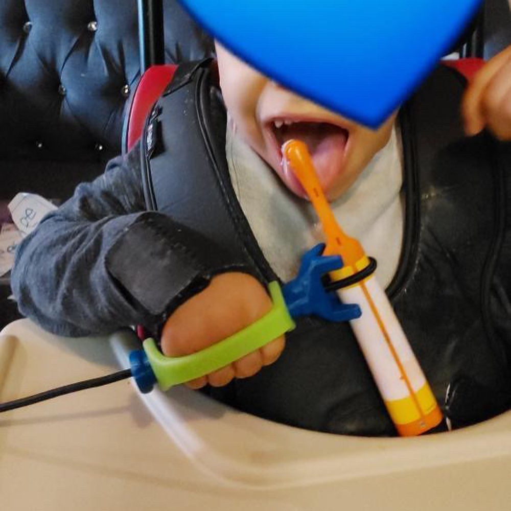 An image of a child brushing their teeth