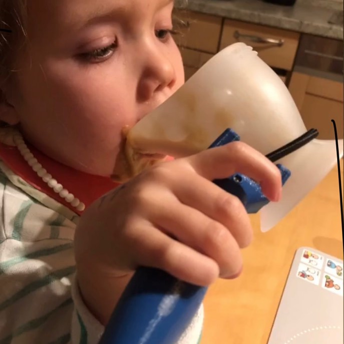 An image of a child using the functionalhand to help them drink from a cup