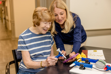Celine and senior adult using functionalhand and stylus