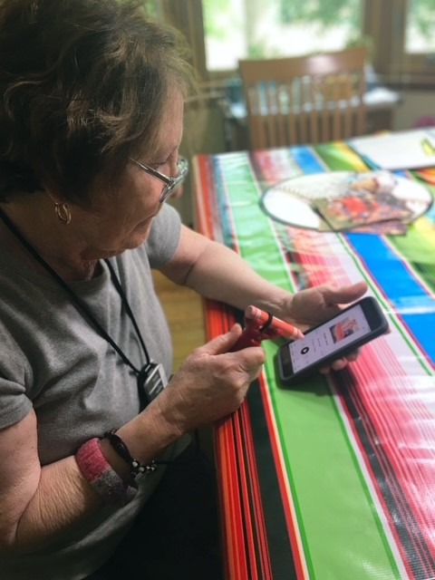 Senior adult using functionalhand and stylus for her phone