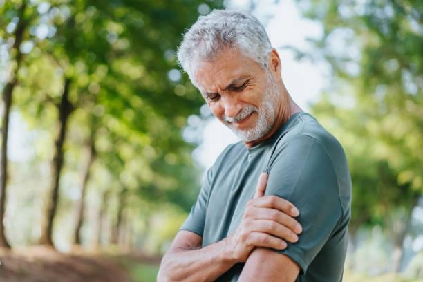 Elder man feeling arm fatigue