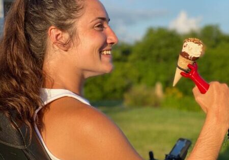 Teenage girl holding an ice cream cone with the functionalhand® enjoying a summer treat.