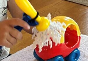 Universal cuff for children being used by a toddler playing with a toy